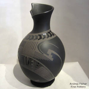 Click to see a larger version An organic opening and Paquime designs on a black on black on black vase