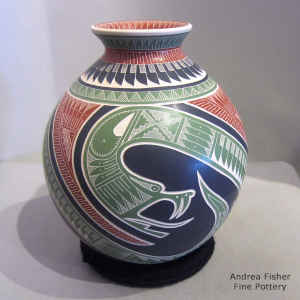 Click to see a larger version Lightly carved, sgraffito and painted serpent and geometric design on a polychrome jar
